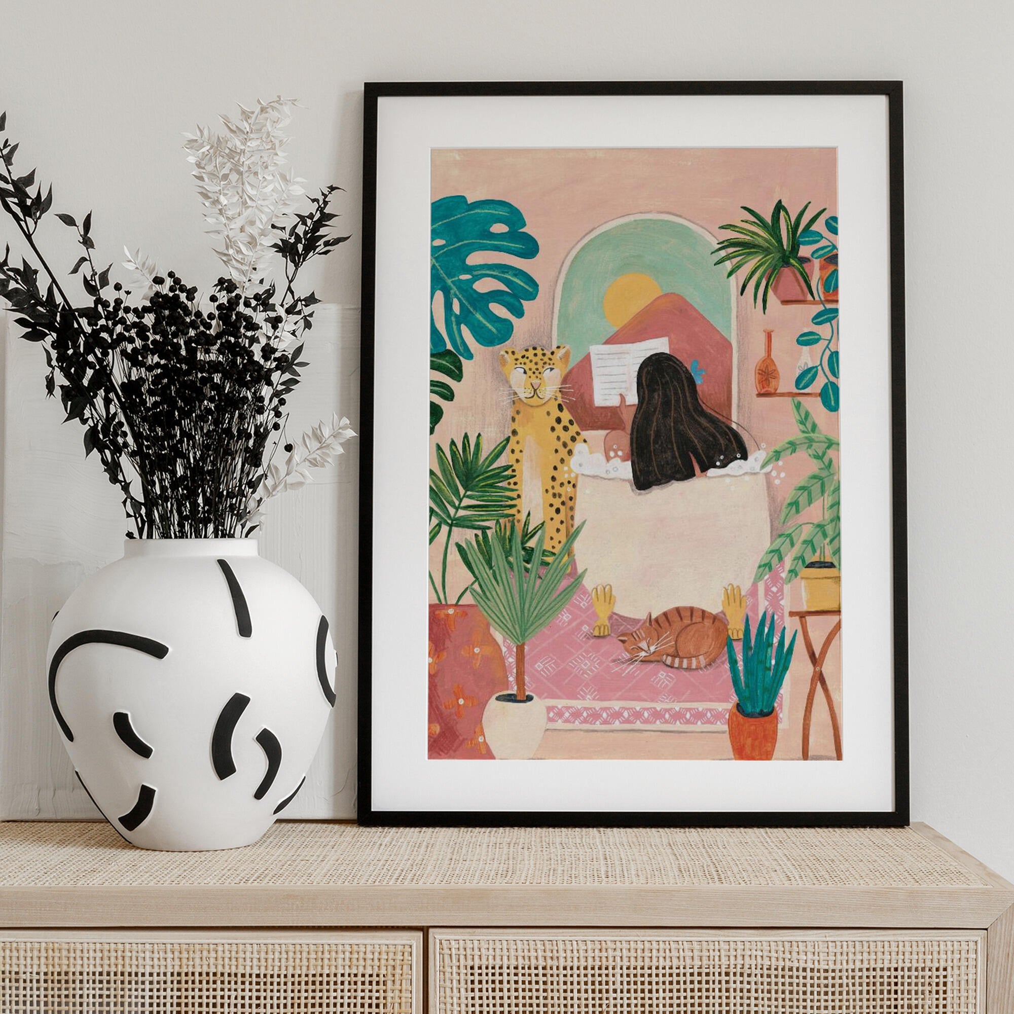 Woman taking bath in pink tropical bathroom