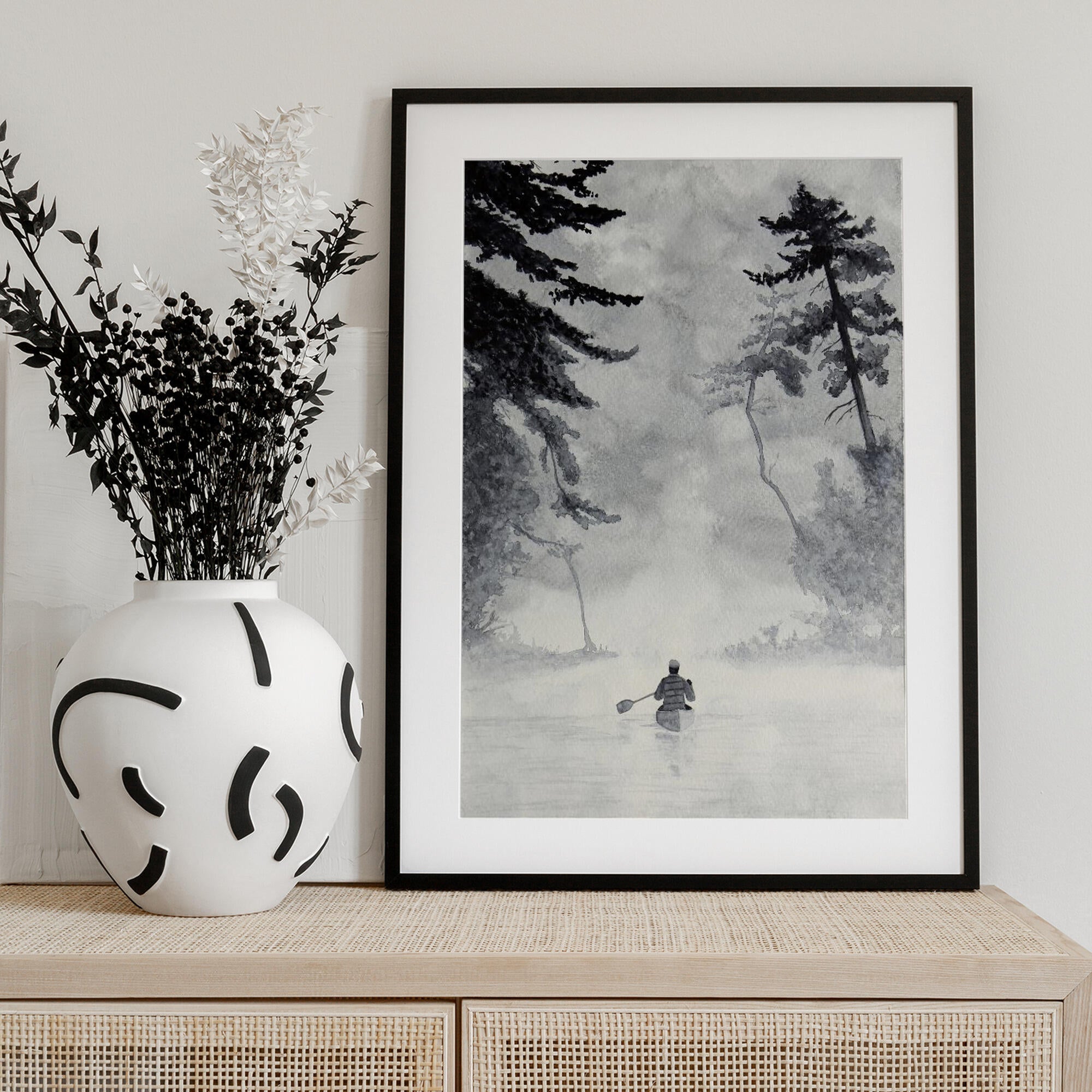 Man In a Canoe On Misty Water In a Forest Landscape